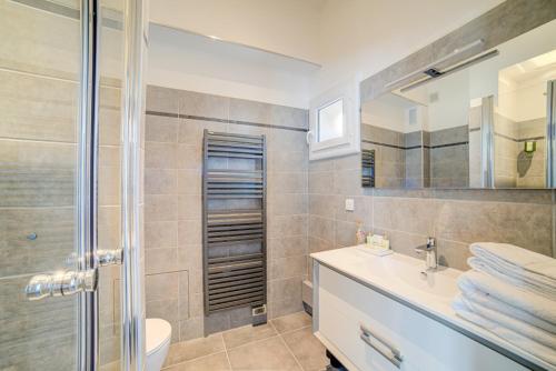 a bathroom with a sink and a toilet and a shower at Le Limas in Avignon