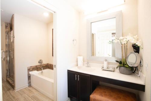 a bathroom with a sink and a mirror at The Colonies at Williamsburg in Williamsburg