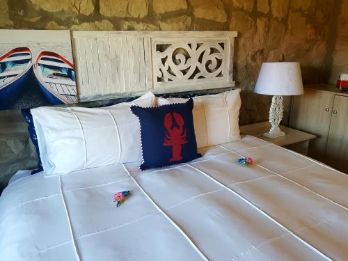 a large white bed with pillows on top of it at Affi lande Boetiek guestfarm in Fouriesburg