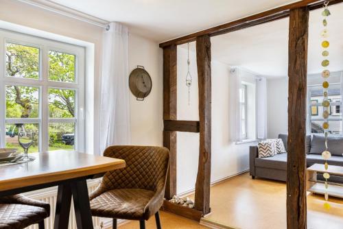 a dining room with a table and a clock on the wall at Dommelhof Ferienwohnungen in Diemelsee