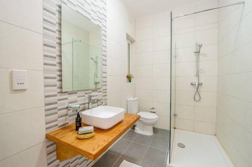 a bathroom with a sink and a toilet and a shower at Hillock Residence Marsalforn in Marsalforn