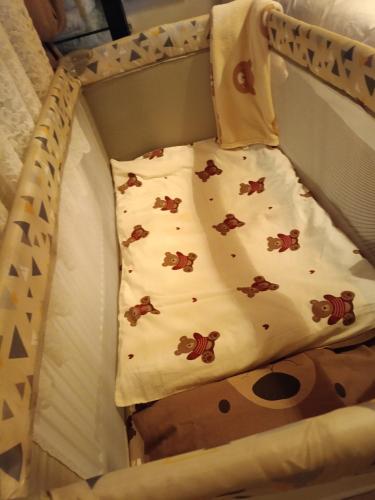 a bed with a pillow in a crib at Rooster Retreat in Aridaia