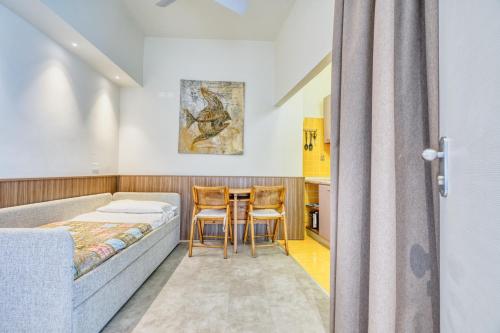a bedroom with a bed and a table and chairs at Hotel Everest - Bar e Ristorante in Gabicce Mare