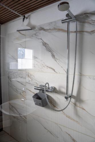 a shower in a bathroom with a marble wall at Alpenblick-Raggal in Raggal