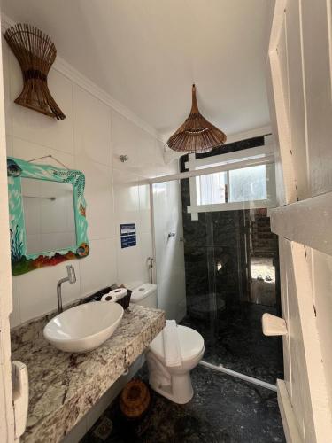 a bathroom with a sink and a toilet at Blue Ocean Flats in Itacaré
