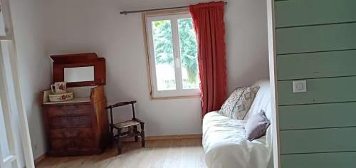 a living room with a couch and a window at Maison La Voyageuse in Gorses