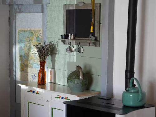 a room with a counter with a vase and a mirror at Maison La Voyageuse in Gorses