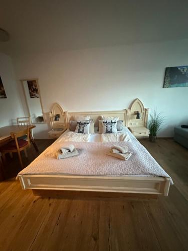 a bedroom with a large bed with two towels on it at Steinbock Apartement in Bad Goisern