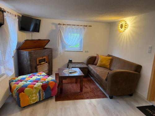 a living room with a couch and a table at Ferienwohnung Mutzelnest in Kurort Gohrisch