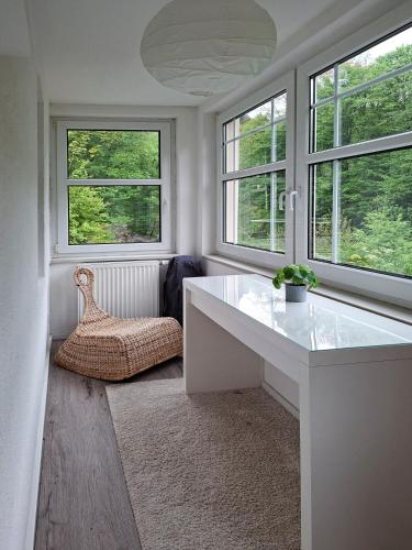 a room with a white desk and two windows at Villa Amselgrund in Rathen