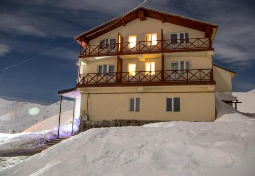 a house on top of a pile of snow at Hotel Deka in Gudauri