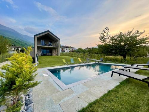 a swimming pool in the yard of a house at Villa Tarca - Colico, Lake Como in Colico
