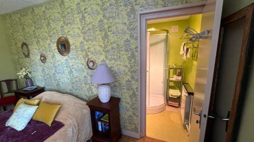 a bedroom with a bed and a bathroom at Villa Tronçais in Saint-Bonnet-Tronçais