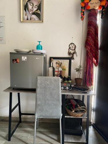 a desk with a computer and a chair in a room at Glamping sin salir de la CDMX in Mexico City