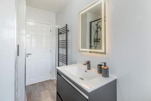 a bathroom with a sink and a mirror at 3 Bed in Skegness oc-b33460 in Orby