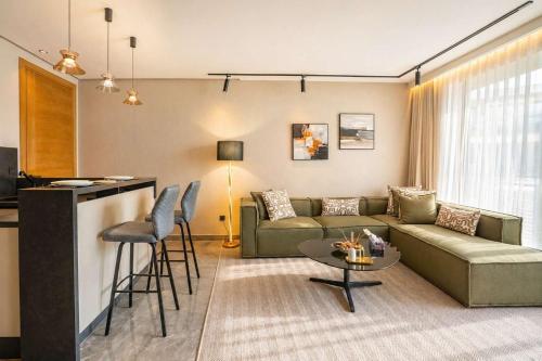 a living room with a couch and a table at The Iconic Spot - Pool and Sea View in Anfa-Supérieur