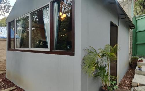 a house with a window on the side of it at Glamping sin salir de la CDMX in Mexico City
