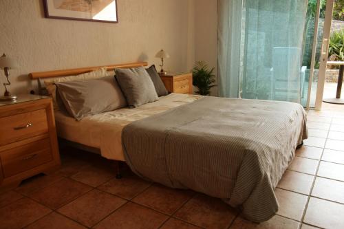 a bedroom with a bed and a dresser and a window at Olous Secret Hideaway - Sea View Studio Elounda in Elounda