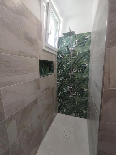 a bathroom with a shower with a green plant at Villa Maddalena Brianza in Lentate sul Seveso
