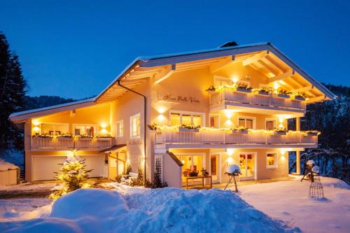 a house in the snow at night at Haus Bella Vista in Reit im Winkl