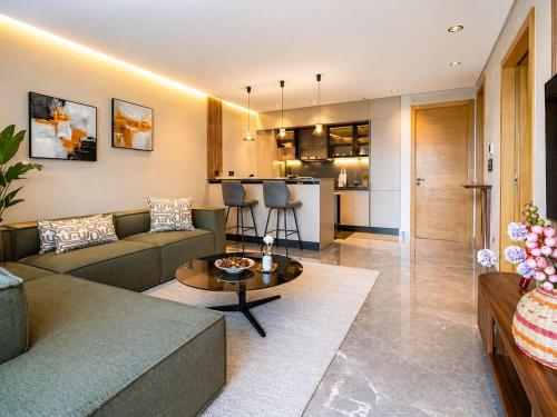 a living room with a couch and a table at The Magic Place - Ocean Walk and Pool Access in Anfa-Supérieur