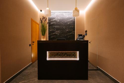 a reception desk with a sign on it in a room at Diplomatico Hotel in Odesa