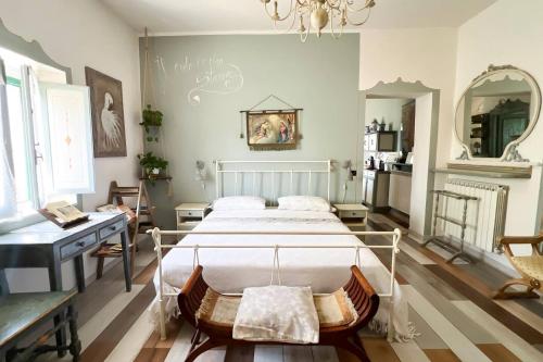 a bedroom with a bed and a desk and a mirror at Antico Leccio Green in Coppe