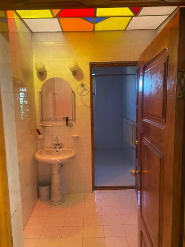 a bathroom with a sink and a shower with a rainbow ceiling at Heritage Garden Villa by Eldar in Ganja