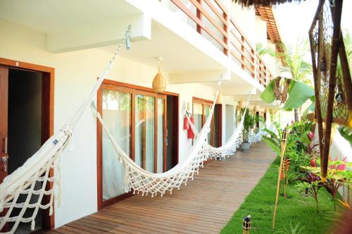 a couple of hammocks on the porch of a house at Pousada Waikiki Boutique in Pipa