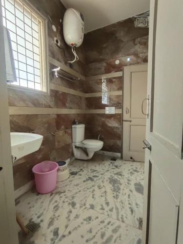 a bathroom with a toilet and a sink at Om Homestay in Panchkula