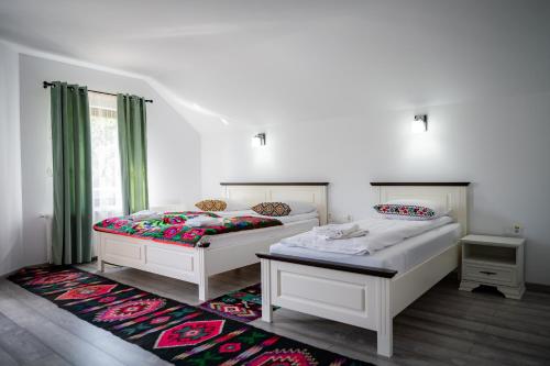 a bedroom with two beds and a rug at Breb 155 in Breb