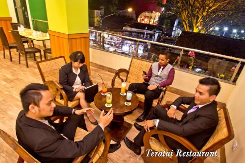 a group of people sitting around a table at Green Batara Hotel in Bandung