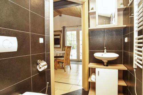 a bathroom with a sink and a toilet at Chalet Ostsee Nr 72 in Göhren
