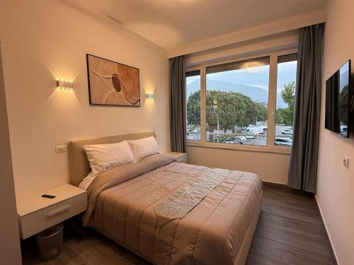 a hotel room with a bed and a window at Residence Meraviglia in Schio
