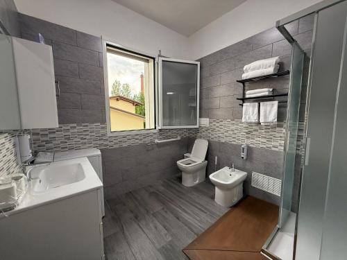 a bathroom with a sink and a toilet and a window at Residence Meraviglia in Schio