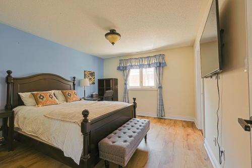 a bedroom with a bed and a television in it at Harmony House in Richmond Hill