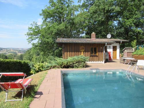 a house with a swimming pool next to a building at Feriendorf Mengshausen 1 in Niederaula