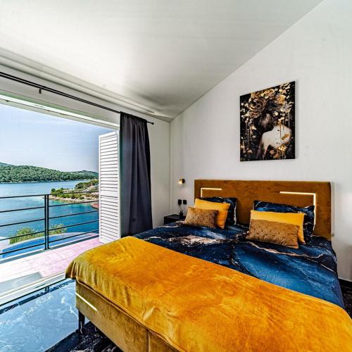 a bedroom with a large bed and a large window at Villa Love house in Vela Luka
