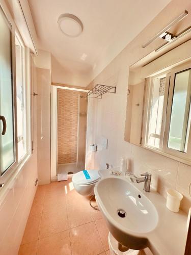 a bathroom with a sink and a toilet in it at Hotel Playa in Bibione