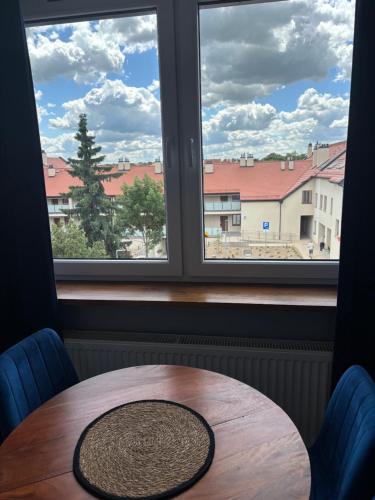 a table in front of a window with a view at Apartament Nova Starówka 2 in Konin