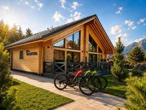 a group of bikes parked in front of a building at Vila Valentina Luxury Chalet in High Tatras in Veľká Lomnica