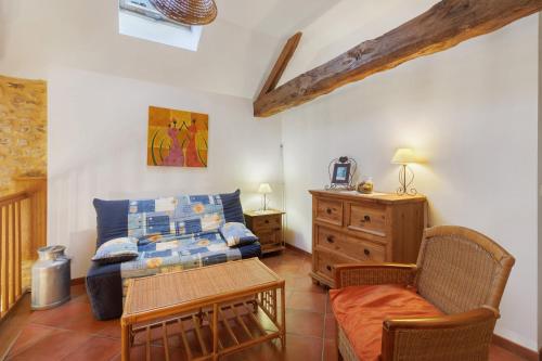 a living room with a couch and a table at Maison de vacances Le Tilleul in Saint-Pompont