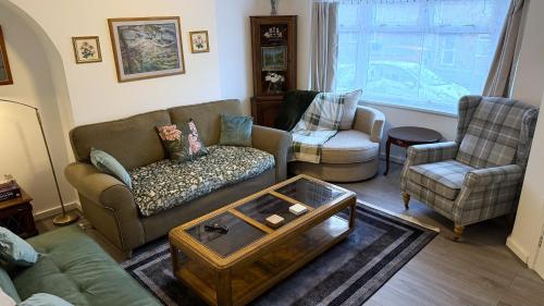 a living room with two couches and a coffee table at Peake Edge Home in Chesterfield