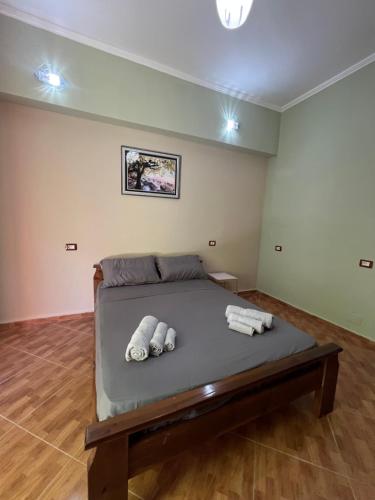 a bedroom with a bed with two pillows on it at Selim Guesthouse 2 in Lybeshë
