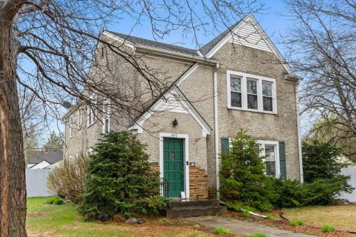 a large brick house with a green door at Main Street Suite in Anoka