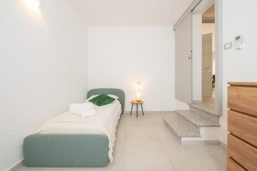 a bedroom with a bed and a small table at Domus Alba in Teulada