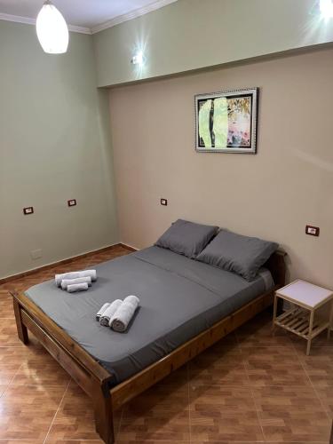 a bedroom with a large bed with towels on it at Selim Guesthouse 2 in Lybeshë