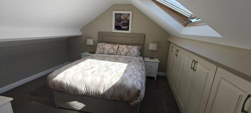 a attic bedroom with a bed and a skylight at Sli Na Mara in Galway