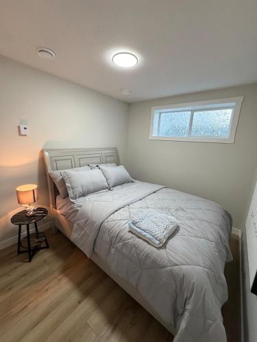 a bedroom with a large bed with a window at The Onyx Suite Sleek Modern Space Private Entry in Regina
