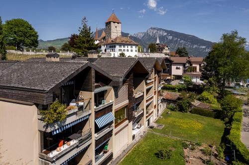 an aerial view of a building with a mountain in the background at Buchtoase in Spiez